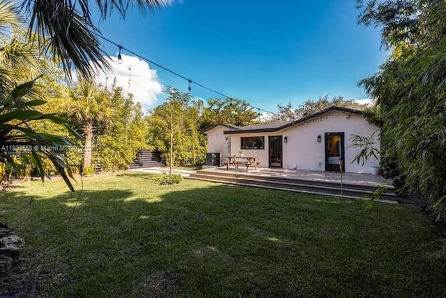 4228 NW 3rd Ave, Miami, FL 33127 - view of green lawn with a deck