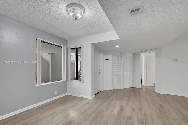 8275 SW 152nd Ave Unit D110, Miami, FL 33193 - spare room with a textured ceiling, wood finished floors, and baseboards