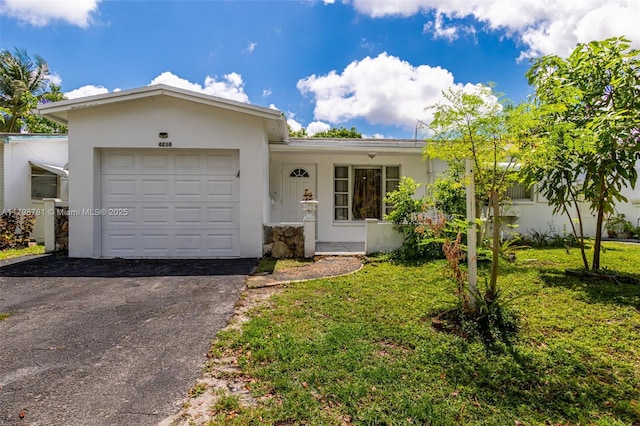 4216 NW 52nd Ave, Lauderdale Lakes, FL 33319 - ranch-style house with an attached garage, a front yard, stucco siding, and asphalt driveway