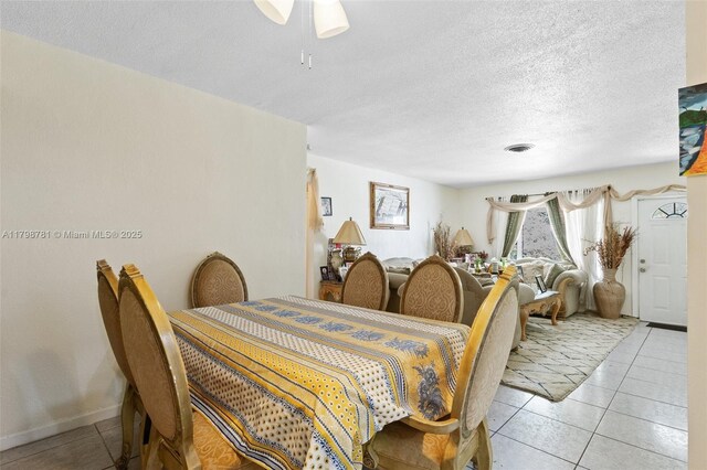 4216 NW 52nd Ave, Lauderdale Lakes, FL 33319 - dining area with light tile patterned floors, a ceiling fan, and a textured ceiling