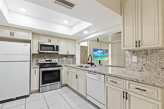4216 NW 52nd Ave, Lauderdale Lakes, FL 33319 - kitchen featuring appliances with stainless steel finishes, cream cabinets, a sink, light tile patterned floors, and recessed lighting