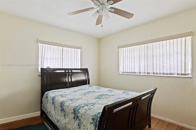 4216 NW 52nd Ave, Lauderdale Lakes, FL 33319 - bedroom with baseboards, wood finished floors, and a ceiling fan