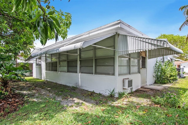 4216 NW 52nd Ave, Lauderdale Lakes, FL 33319 - view of side of property with a wall unit AC and a sunroom