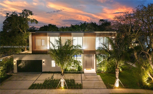 view of front of house with a garage and concrete driveway
