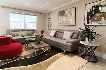 581 Blue Heron Dr Unit 318-B, Hallandale Beach, FL 33009 - living area featuring ornamental molding, concrete flooring, and recessed lighting