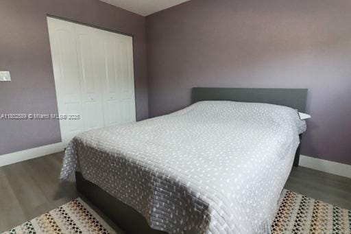 581 Blue Heron Dr Unit 318-B, Hallandale Beach, FL 33009 - bedroom with baseboards, wood finished floors, and a closet