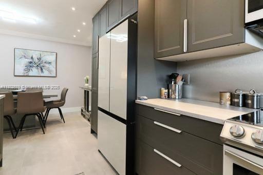 581 Blue Heron Dr Unit 318-B, Hallandale Beach, FL 33009 - kitchen featuring freestanding refrigerator, electric stove, light countertops, and recessed lighting
