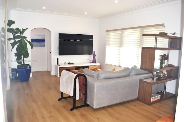 465 NE 52nd St, Miami, FL 33137 - living area featuring light wood-type flooring, ornamental molding, baseboards, recessed lighting, and arched walkways