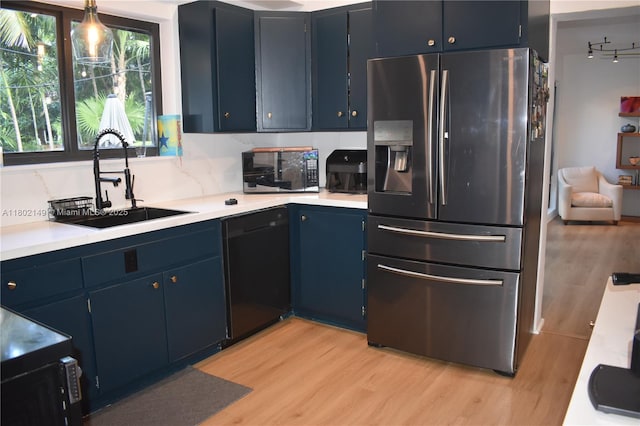 465 NE 52nd St, Miami, FL 33137 - kitchen with stainless steel fridge with ice dispenser, black dishwasher, a sink, and light wood finished floors