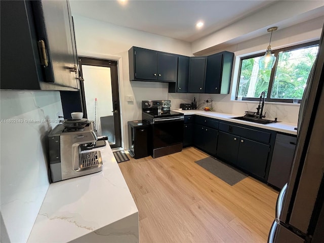 465 NE 52nd St, Miami, FL 33137 - kitchen with electric range, a sink, light wood-type flooring, dark cabinetry, and recessed lighting