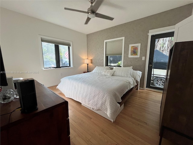 465 NE 52nd St, Miami, FL 33137 - bedroom featuring multiple windows, wood finished floors, access to outside, and a ceiling fan