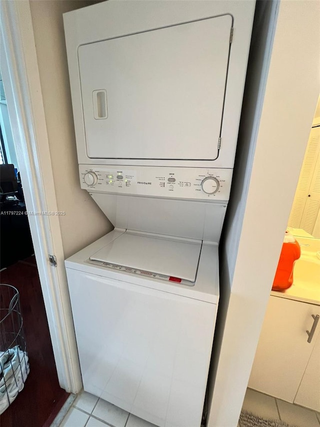 3300 NE 192nd St Unit 803, Aventura, FL 33180 - washroom with stacked washer / drying machine and tile patterned floors