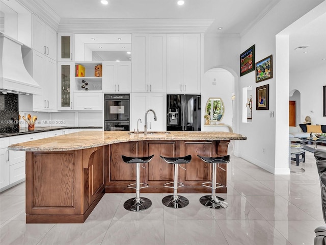 3230 SW 194th Ter, Miramar, FL 33029 - kitchen with black appliances, a sink, arched walkways, decorative backsplash, and ornamental molding