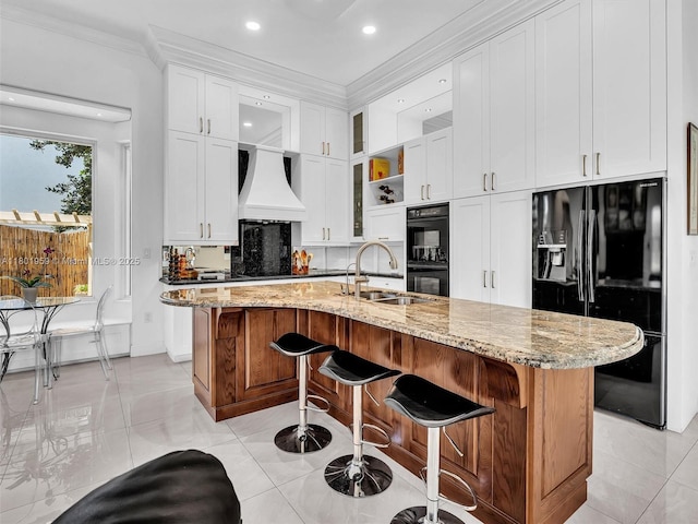 3230 SW 194th Ter, Miramar, FL 33029 - kitchen with black appliances, custom range hood, crown molding, white cabinetry, and light stone counters