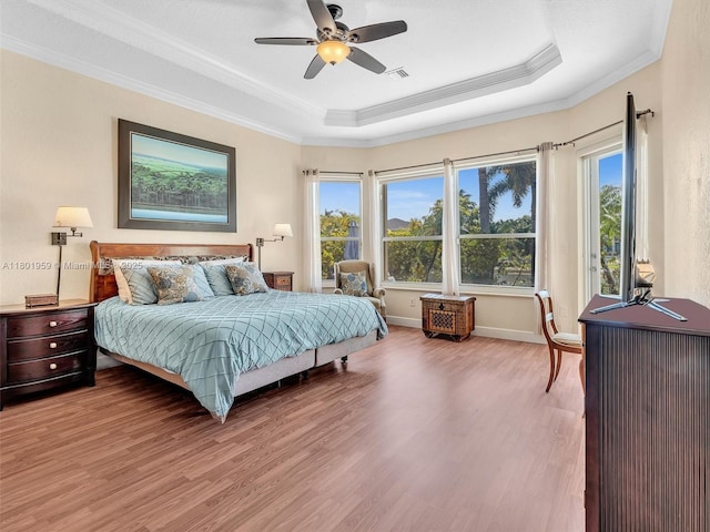 3230 SW 194th Ter, Miramar, FL 33029 - bedroom featuring wood finished floors, a tray ceiling, multiple windows, ornamental molding, and a ceiling fan