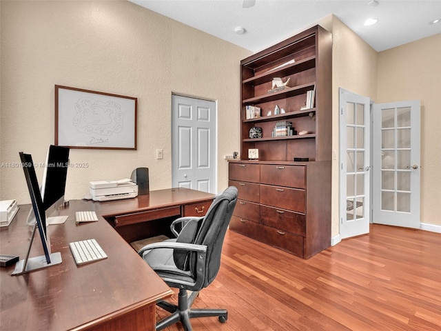 3230 SW 194th Ter, Miramar, FL 33029 - home office featuring light wood-style flooring, french doors, and a textured wall