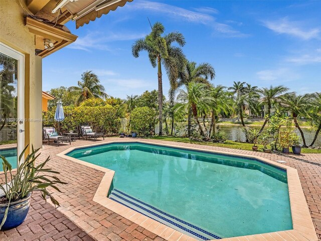 3230 SW 194th Ter, Miramar, FL 33029 - view of swimming pool with a patio and a water view