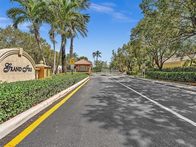 3230 SW 194th Ter, Miramar, FL 33029 - view of asphalt road with curbs, traffic signs, a gated entry, and a gate