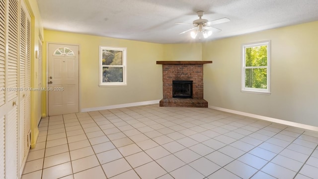 17254 N 32nd Ln N, Loxahatchee, FL 33470 - unfurnished living room featuring ceiling fan, a fireplace, baseboards, and light tile patterned floors