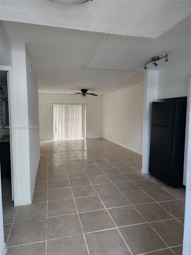 6020 Shakerwood Cir Unit 103, Tamarac, FL 33319 - tiled spare room featuring ceiling fan, rail lighting, and a textured ceiling