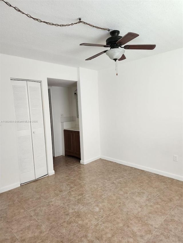 6020 Shakerwood Cir Unit 103, Tamarac, FL 33319 - unfurnished bedroom with baseboards, a closet, a ceiling fan, and a textured ceiling
