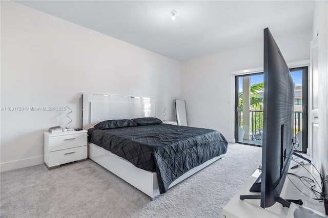 bedroom featuring access to exterior, light colored carpet, and baseboards