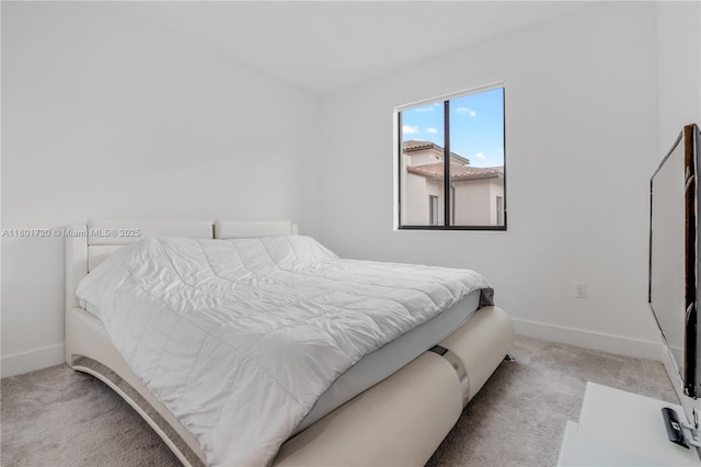 carpeted bedroom featuring baseboards