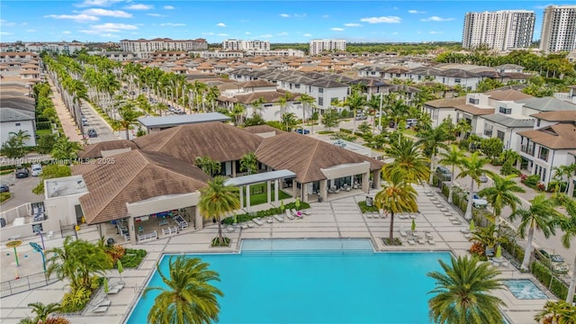 community pool with a patio area and a residential view