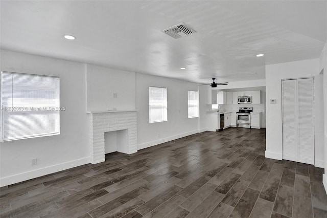 242 SW 9th St, Dania Beach, FL 33004 - unfurnished living room with dark wood-style floors, a ceiling fan, baseboards, recessed lighting, and a fireplace