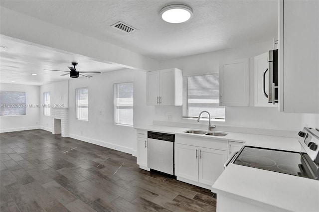 242 SW 9th St, Dania Beach, FL 33004 - kitchen featuring stainless steel dishwasher, a sink, electric range oven, white cabinetry, and light countertops