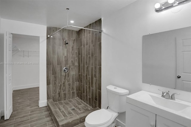242 SW 9th St, Dania Beach, FL 33004 - bathroom with toilet, a tile shower, vanity, recessed lighting, and wood finished floors