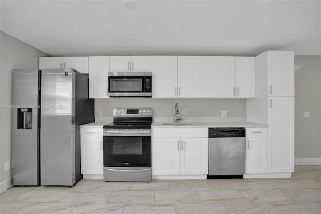 242 SW 9th St, Dania Beach, FL 33004 - kitchen featuring appliances with stainless steel finishes, a sink, light countertops, and white cabinetry