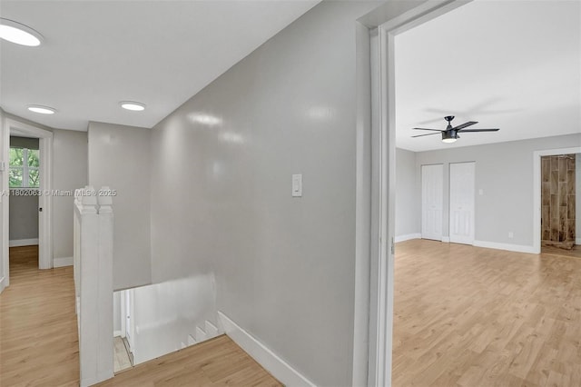 242 SW 9th St, Dania Beach, FL 33004 - hall with an upstairs landing, light wood-type flooring, and baseboards