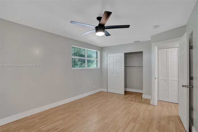 242 SW 9th St, Dania Beach, FL 33004 - unfurnished bedroom featuring baseboards, light wood finished floors, and a closet