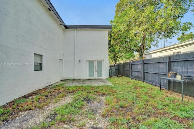 242 SW 9th St, Dania Beach, FL 33004 - rear view of house with french doors, fence, a patio, stucco siding, and central AC unit