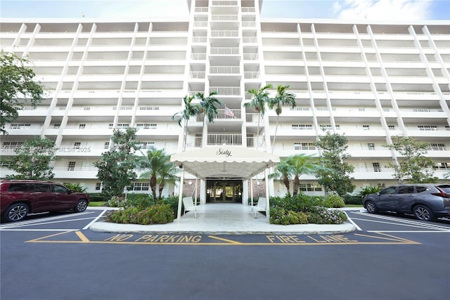 605 Oaks Dr Unit 203, Pompano Beach, FL 33069 - view of building exterior featuring uncovered parking