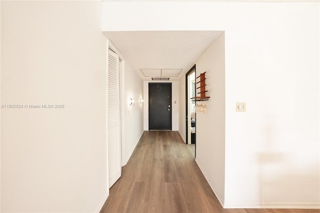 605 Oaks Dr Unit 203, Pompano Beach, FL 33069 - hall with attic access, wood finished floors, and baseboards