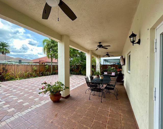 4619 SW 164th Pl, Miami, FL 33185 - view of patio / terrace featuring ceiling fan, a fenced backyard, and outdoor dining area