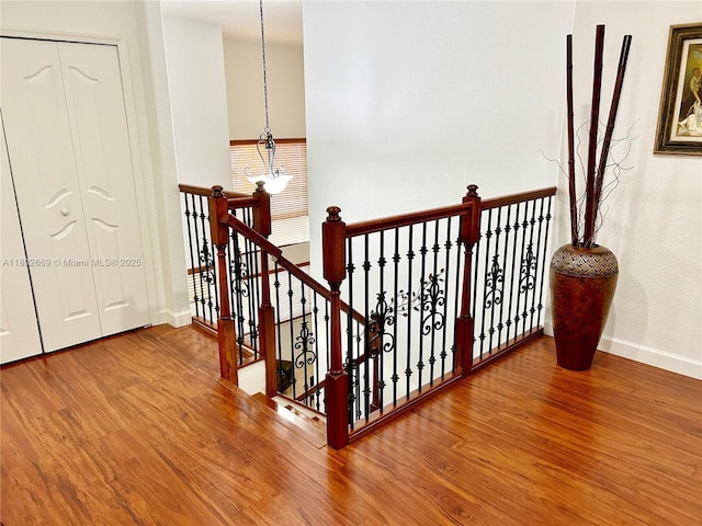 4619 SW 164th Pl, Miami, FL 33185 - stairs with wood finished floors, baseboards, and a chandelier