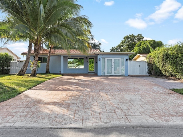 6820 SW 9th St, Pembroke Pines, FL 33023 - view of front facade with french doors, a gate, stucco siding, and decorative driveway