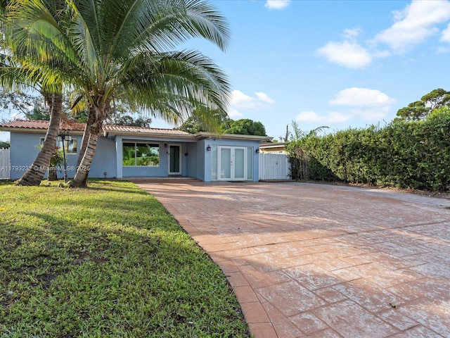 6820 SW 9th St, Pembroke Pines, FL 33023 - ranch-style house with decorative driveway, french doors, and stucco siding