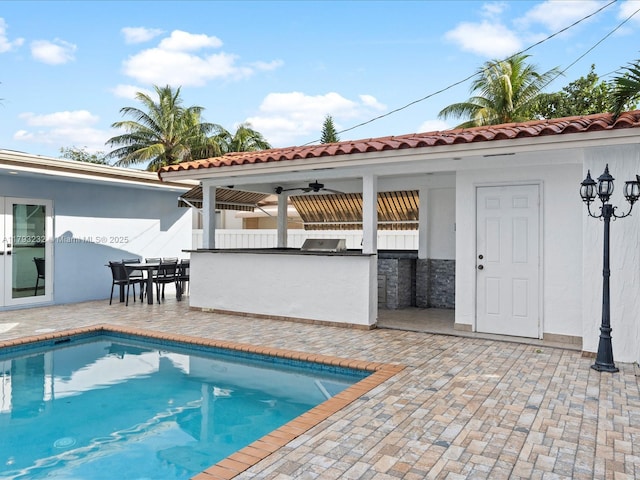 6820 SW 9th St, Pembroke Pines, FL 33023 - swimming pool with exterior kitchen, a patio, and a ceiling fan