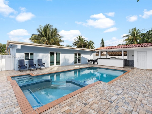 6820 SW 9th St, Pembroke Pines, FL 33023 - view of pool featuring french doors, a patio, an outdoor bar, an outdoor kitchen, and a pool with connected hot tub