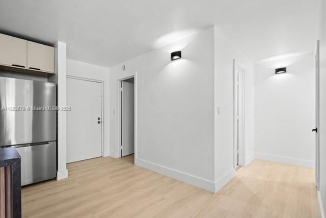 14840 Naranja Lakes Blvd Unit C4B, Homestead, FL 33032 - kitchen with freestanding refrigerator, light wood-style flooring, baseboards, and white cabinetry