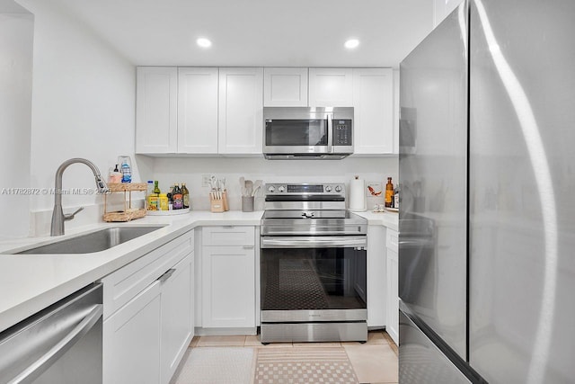 241 W Park Dr Unit 5-103, Miami, FL 33172 - kitchen featuring appliances with stainless steel finishes, a sink, light countertops, white cabinetry, and recessed lighting