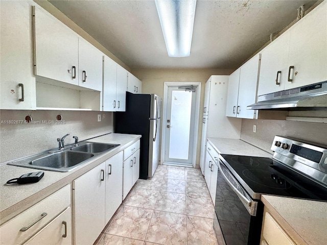 kitchen with appliances with stainless steel finishes, under cabinet range hood, a sink, and light countertops