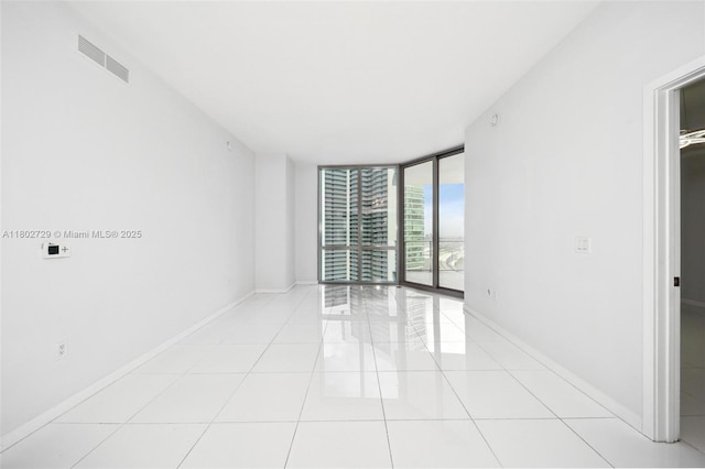851 NE 1st Ave Unit 3107, Miami, FL 33132 - spare room with floor to ceiling windows and light tile patterned floors