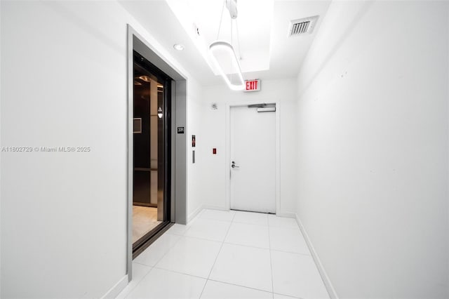 851 NE 1st Ave Unit 3107, Miami, FL 33132 - hallway with light tile patterned floors and elevator