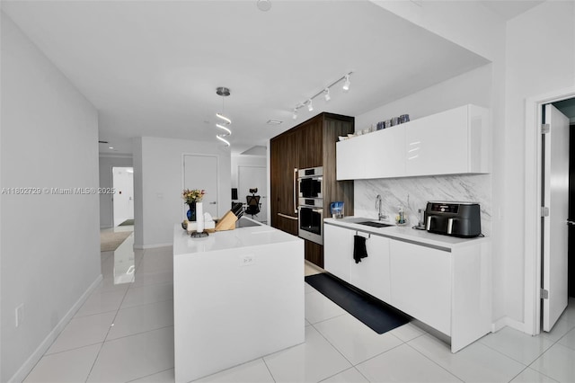 851 NE 1st Ave Unit 3107, Miami, FL 33132 - kitchen featuring a kitchen island, white cabinets, light countertops, double oven, and modern cabinets