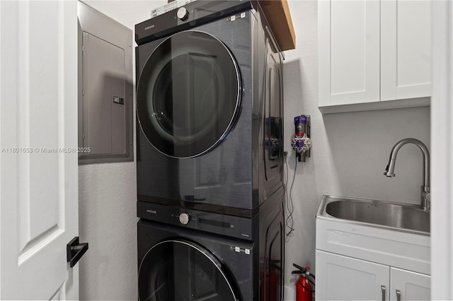 1504 Passion Vine Cir Unit 23-4, Weston, FL 33326 - washroom featuring estacked washer and dryer, cabinet space, and electric panel